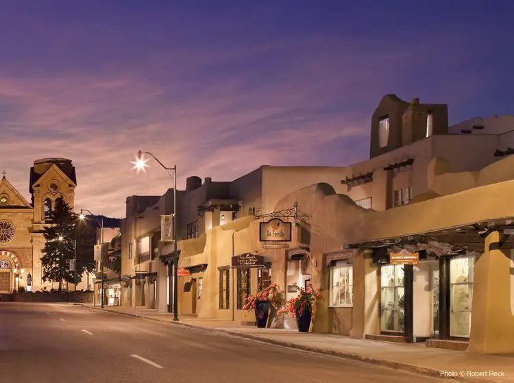 a city street with a clock tower in the background