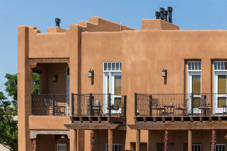 a brown building with two balconies and a balcony