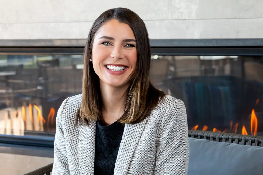 a woman sitting in front of a fire place