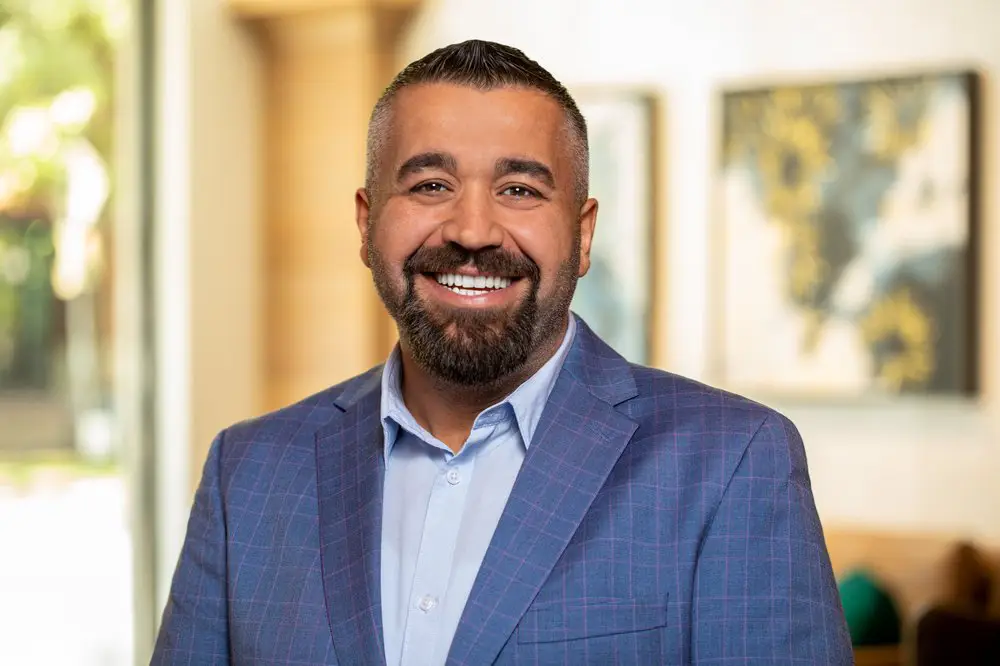 a man with a beard wearing a blue suit