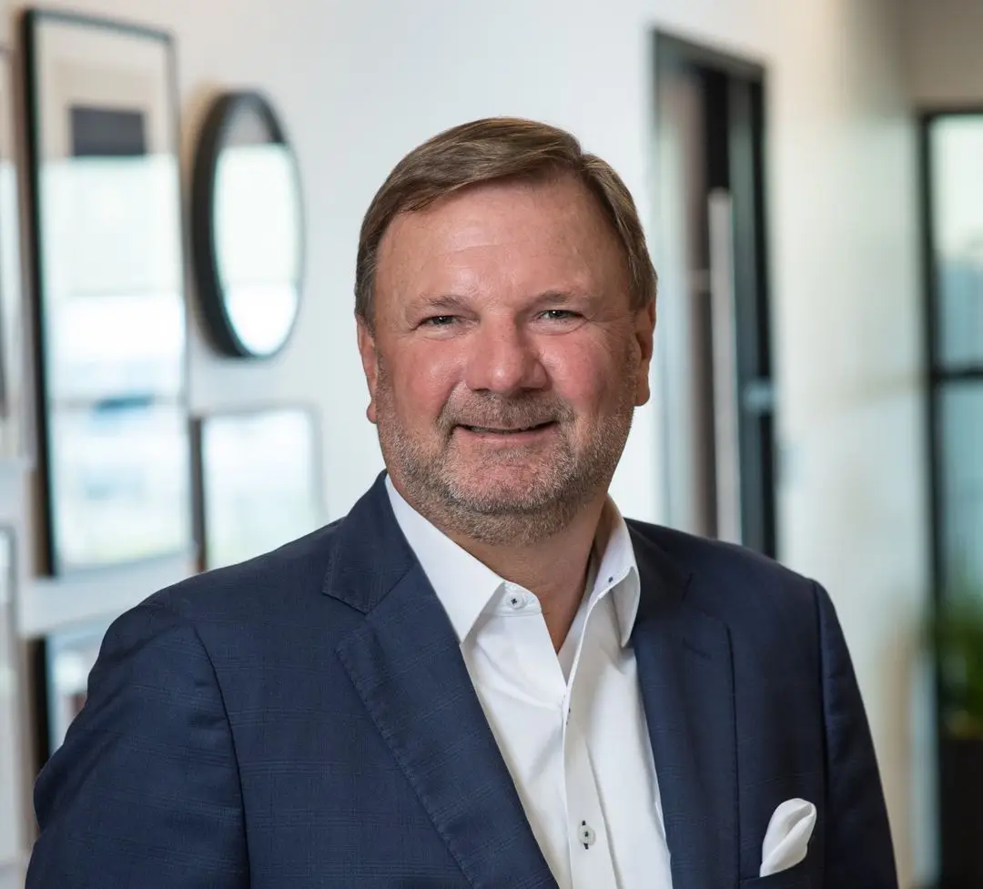 a man in a blue suit and white shirt