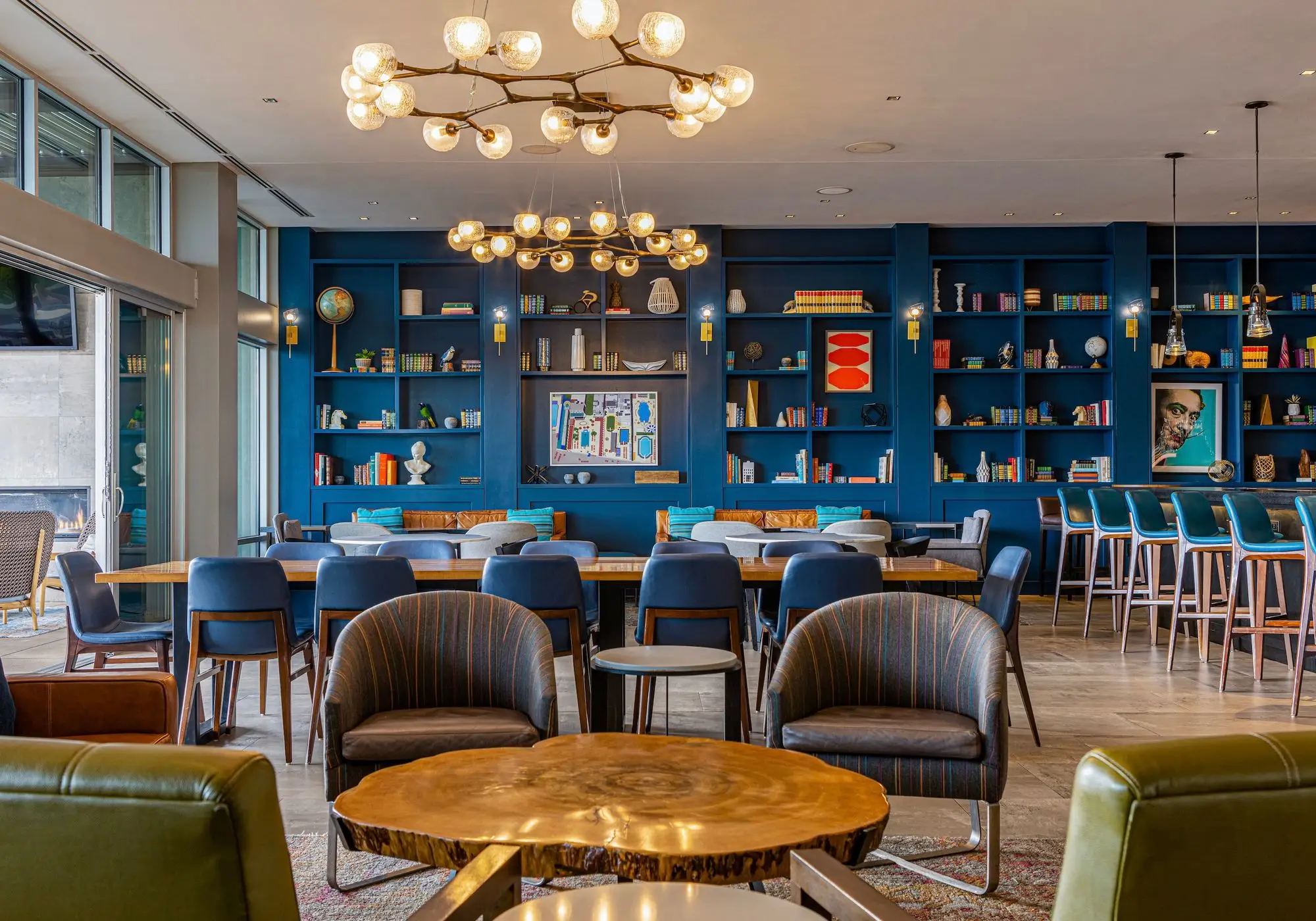 a restaurant with blue walls and wooden tables and chairs